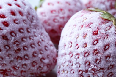 Photo of Frozen ripe strawberries on table, closeup view