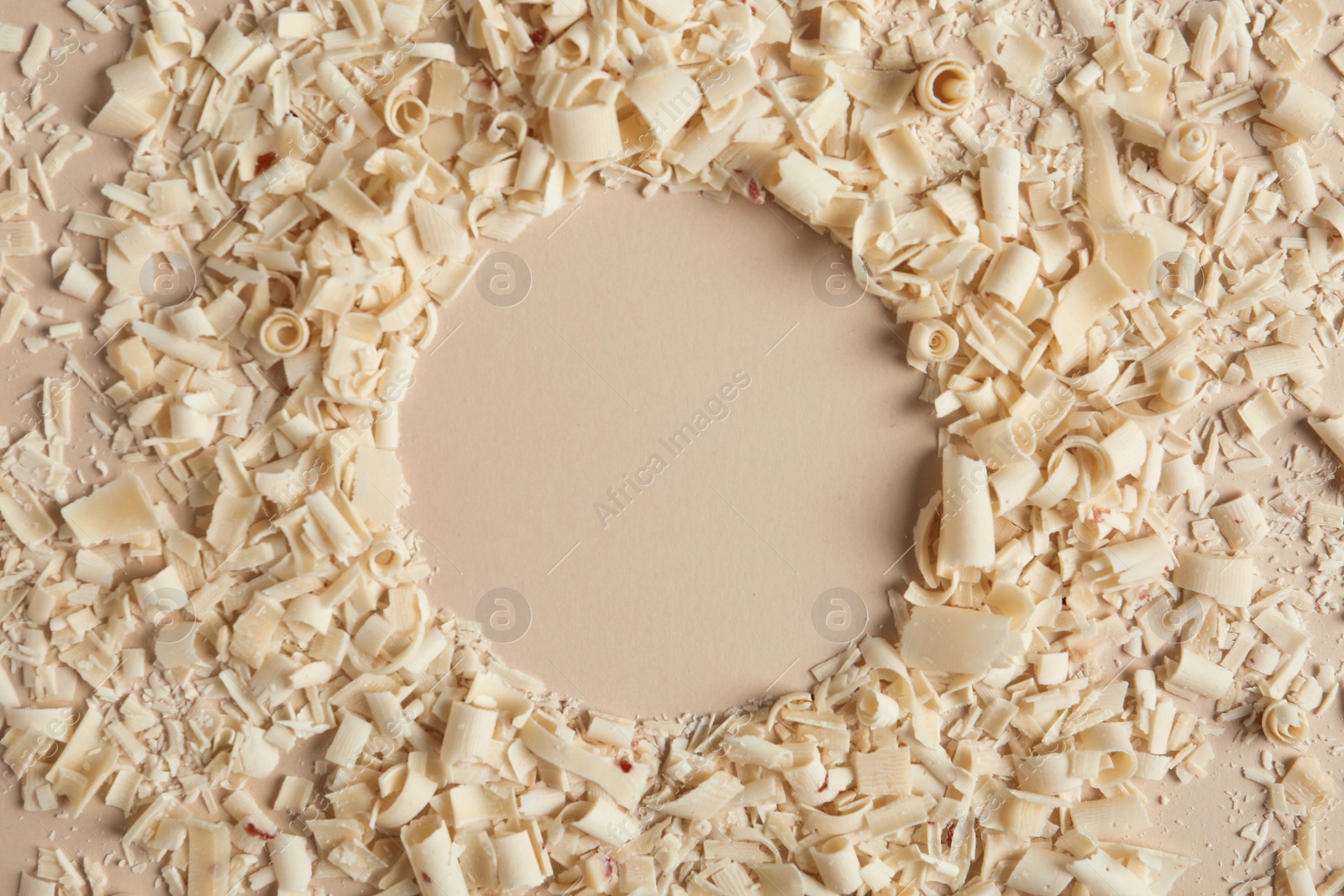 Photo of Flat lay composition with white chocolate curls and space for text on color background