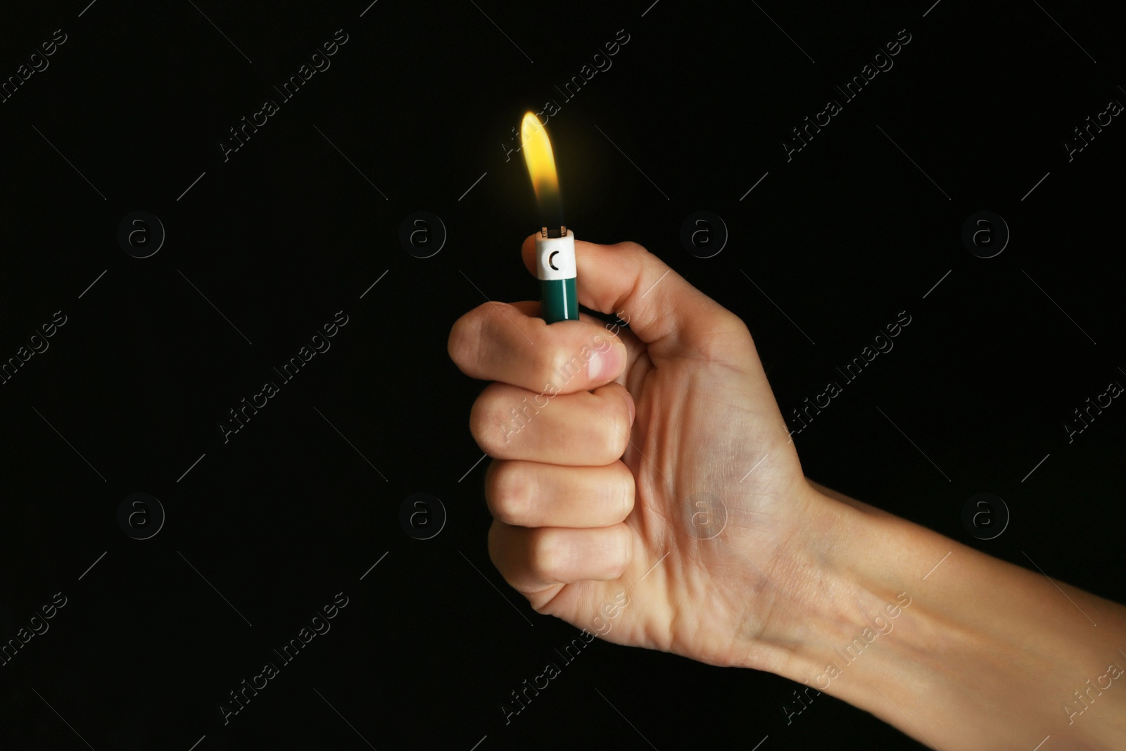 Photo of Woman holding green lighter on black background, closeup
