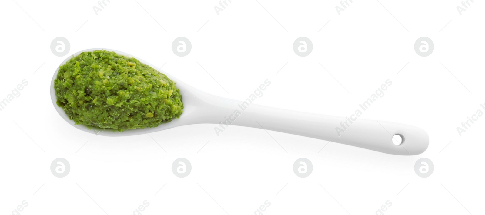 Photo of Spoon with delicious pesto sauce isolated on white, top view