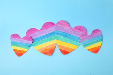 Photo of Rainbow hearts on color background, top view. Gay symbol