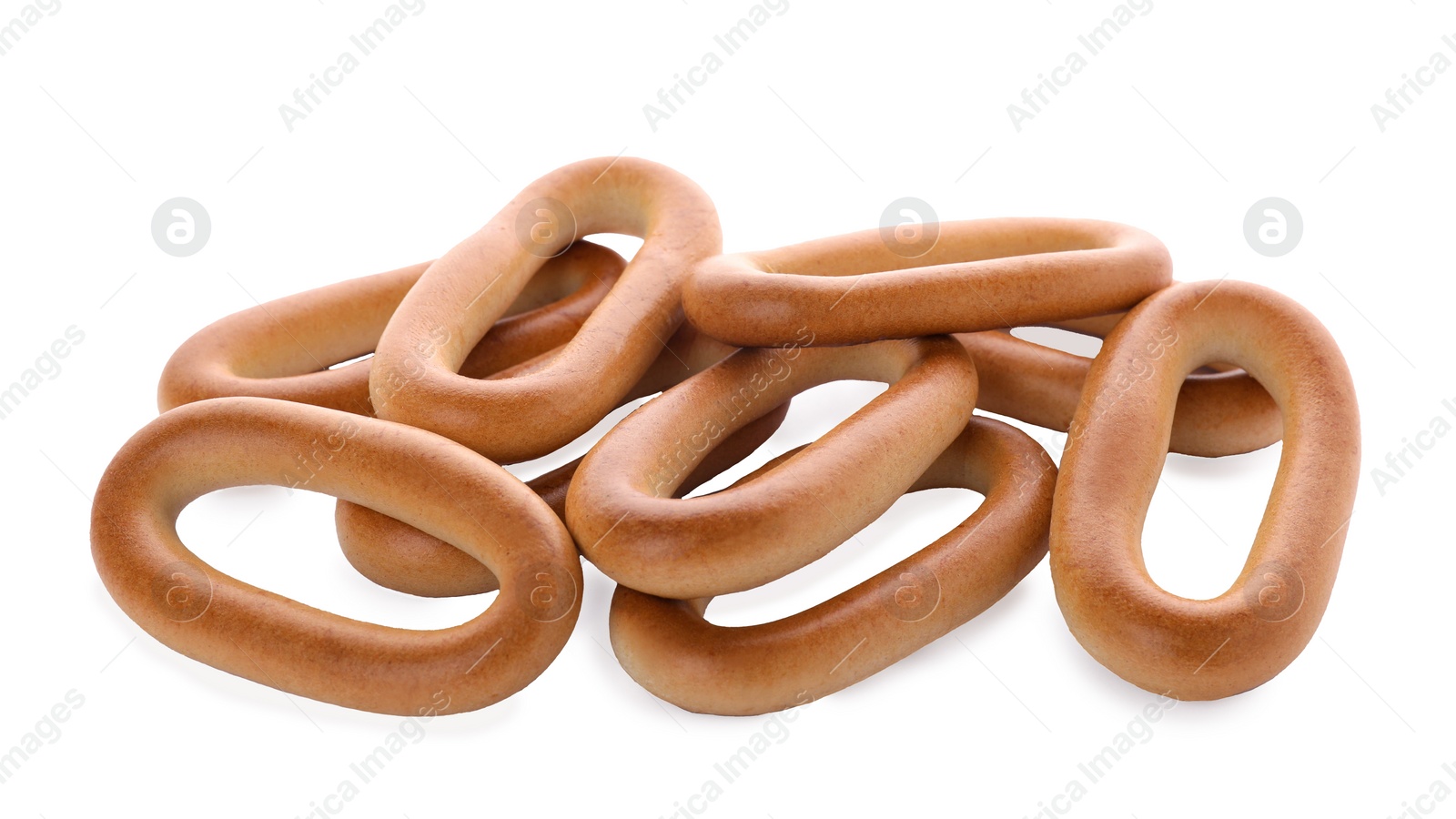 Photo of Many tasty dry bagels (sushki) isolated on white