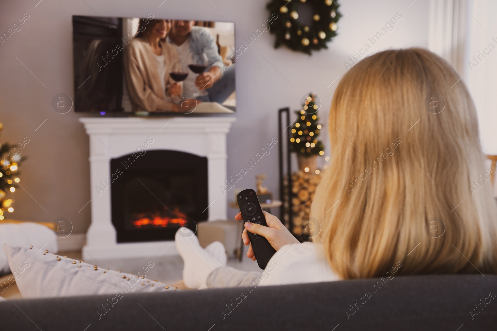 Image of Woman watching romantic movie on TV at home