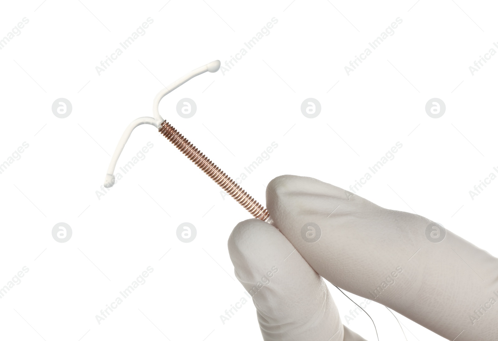 Photo of Gynecologist holding copper intrauterine contraceptive device on white background, closeup