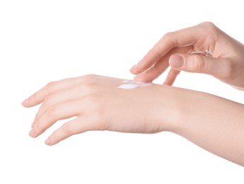 Woman applying cream on her hand against white background, closeup