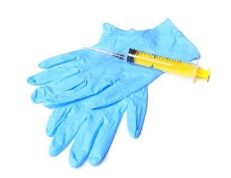 Photo of Medical gloves and empty syringe on white background