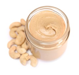 Photo of Tasty nut paste in jar and cashews isolated on white, above view