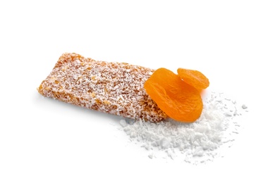 Photo of Grain cereal bar with desiccated coconut and dried apricots on white background