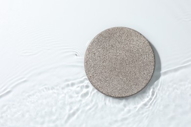 Photo of Presentation for product. Stone podium in water on white background, top view