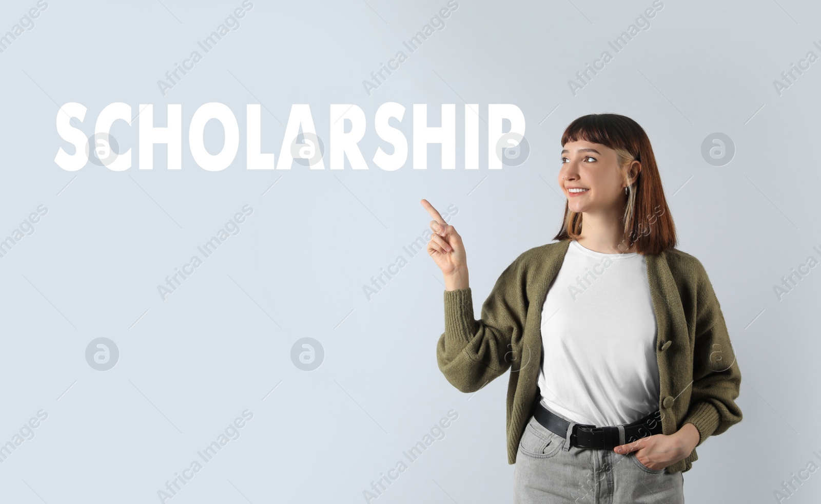 Image of Scholarship concept. Portrait of happy student on light background