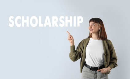 Scholarship concept. Portrait of happy student on light background