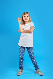 Photo of Cute little girl on light blue background