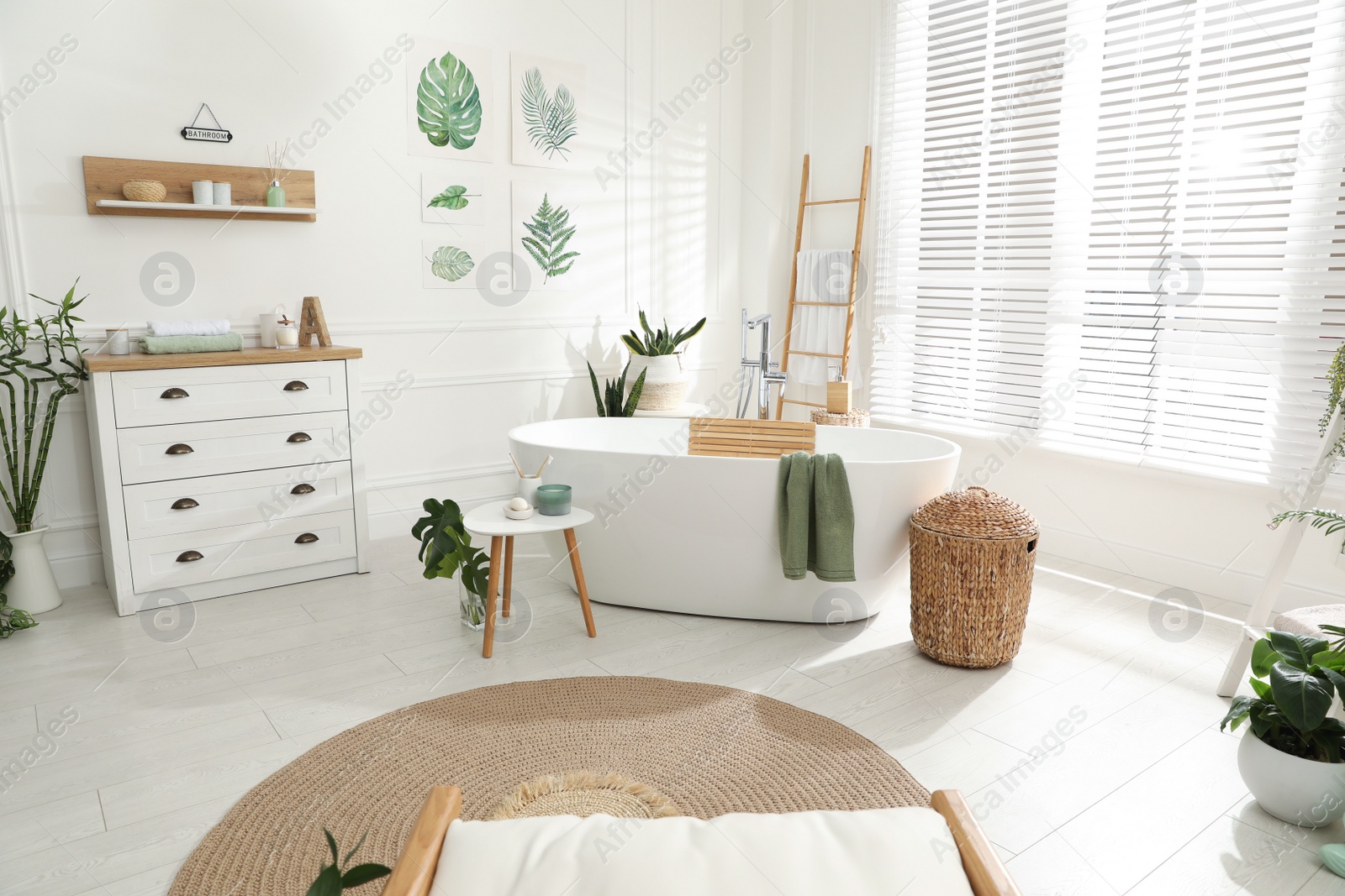 Photo of Stylish bathroom interior with green plants. Home design