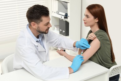 Photo of Doctor giving hepatitis vaccine to patient in clinic