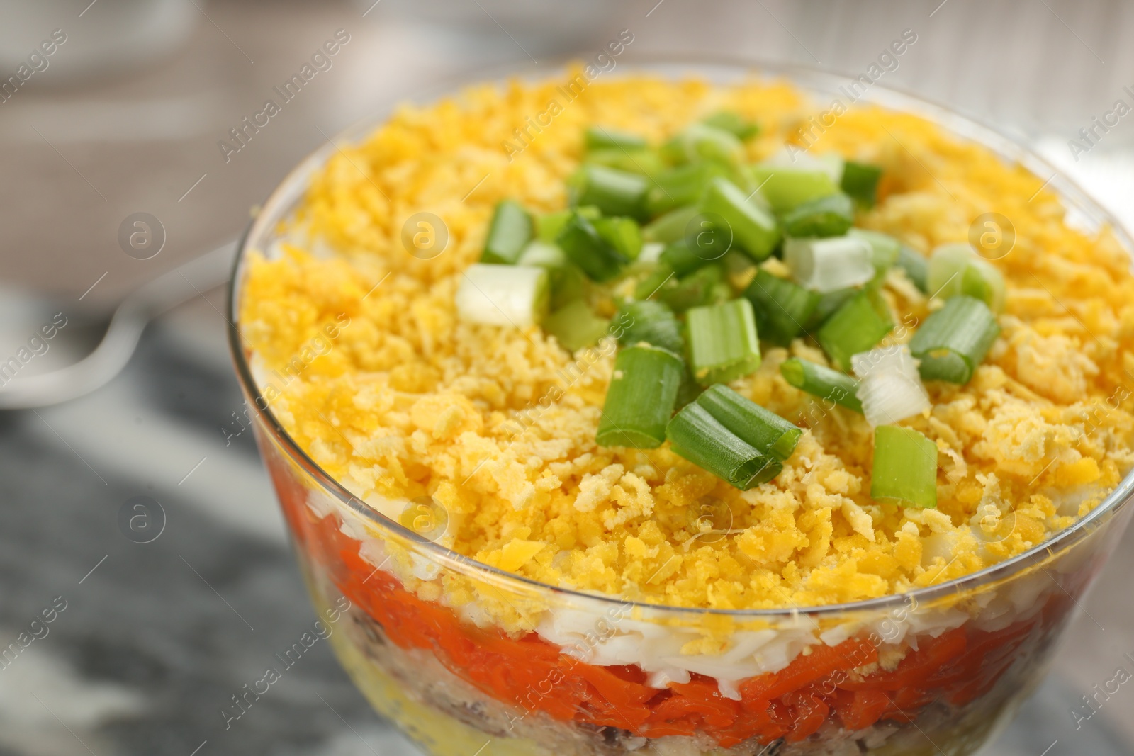 Photo of Traditional russian salad Mimosa on table, closeup