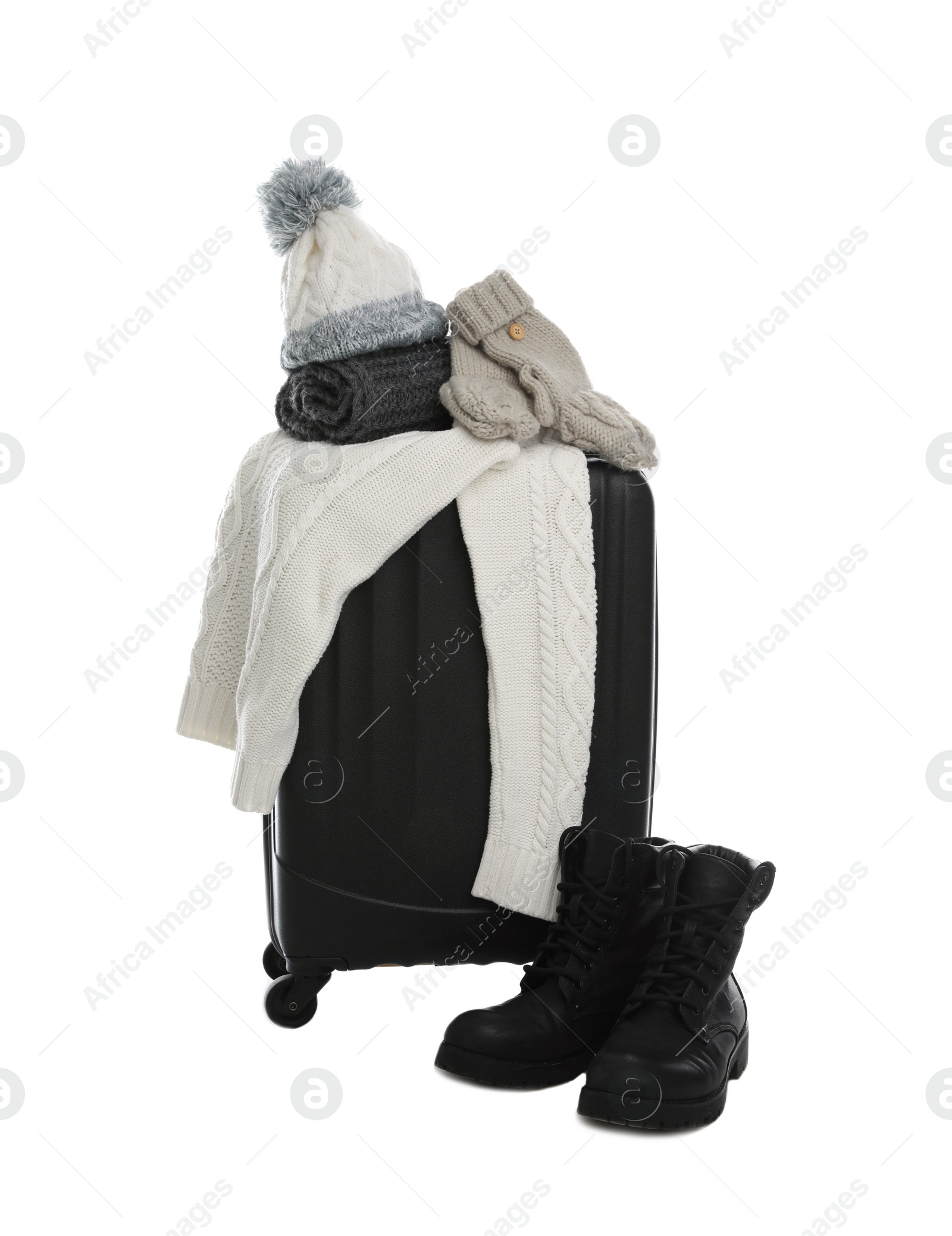 Photo of Suitcase with warm clothes isolated on white. Winter vacation