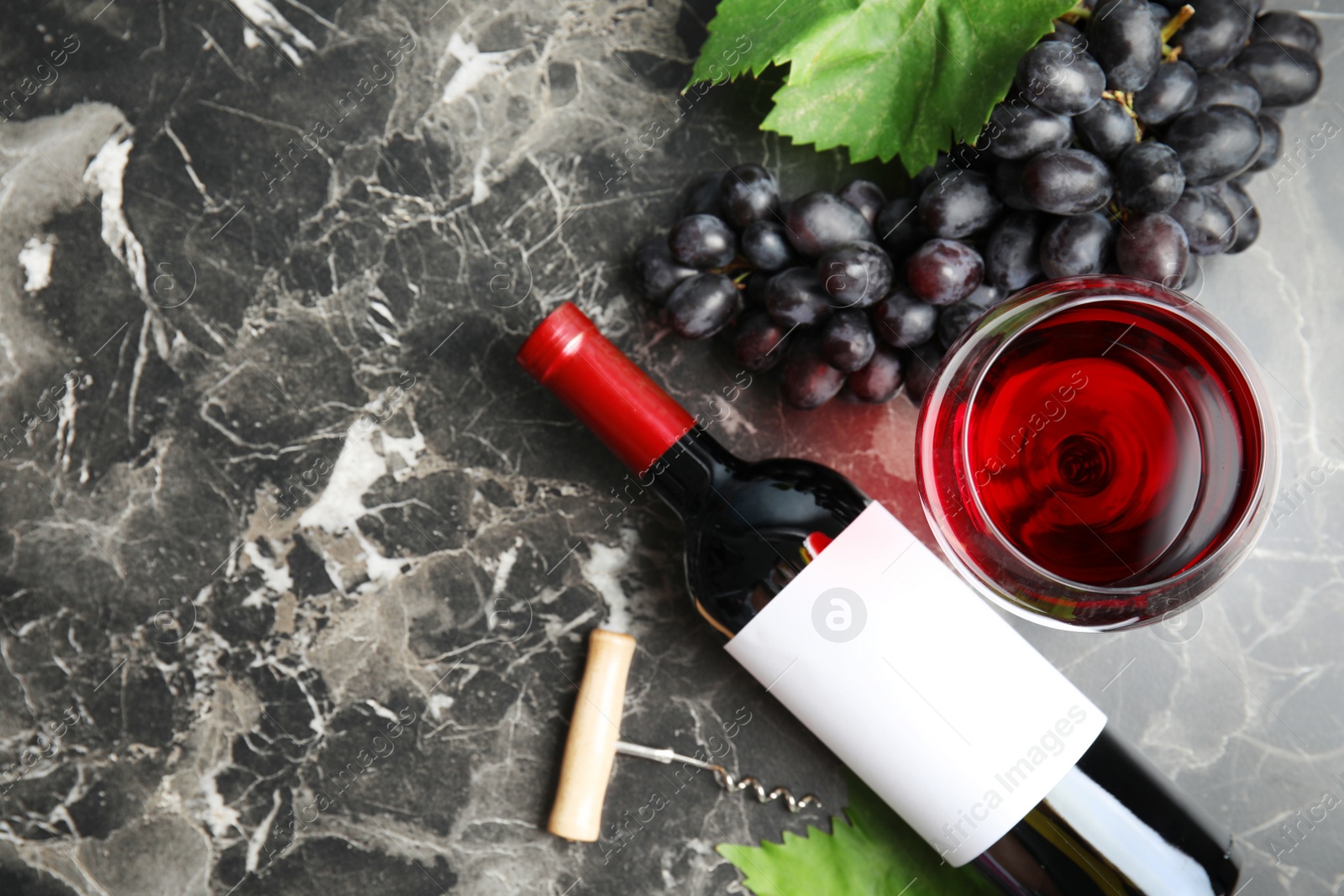 Photo of Flat lay composition with fresh ripe juicy grapes and space for text on table