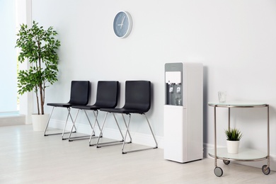 Modern water cooler in stylish office interior