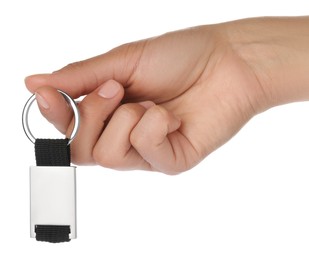 Woman holding metallic keychain on white background, closeup