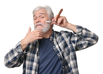 Photo of Senior man shaving beard with blade on white background