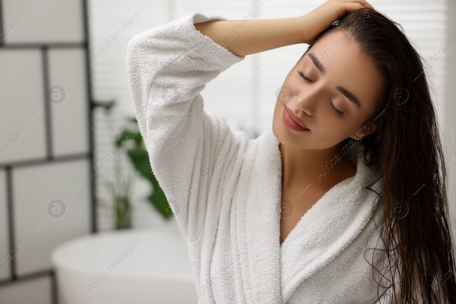 Photo of Beautiful young woman after shower in bathroom