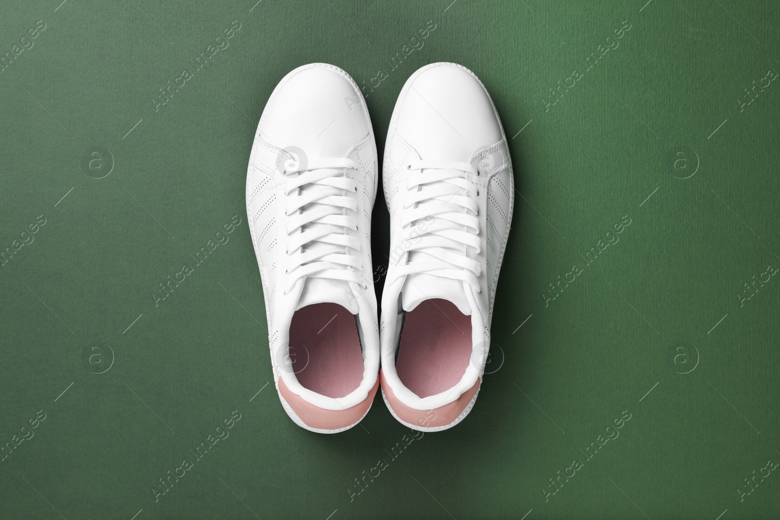 Photo of Pair of sneakers on color background, flat lay