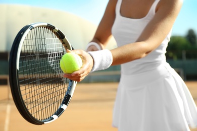 Sportswoman preparing to serve tennis ball at court, closeup