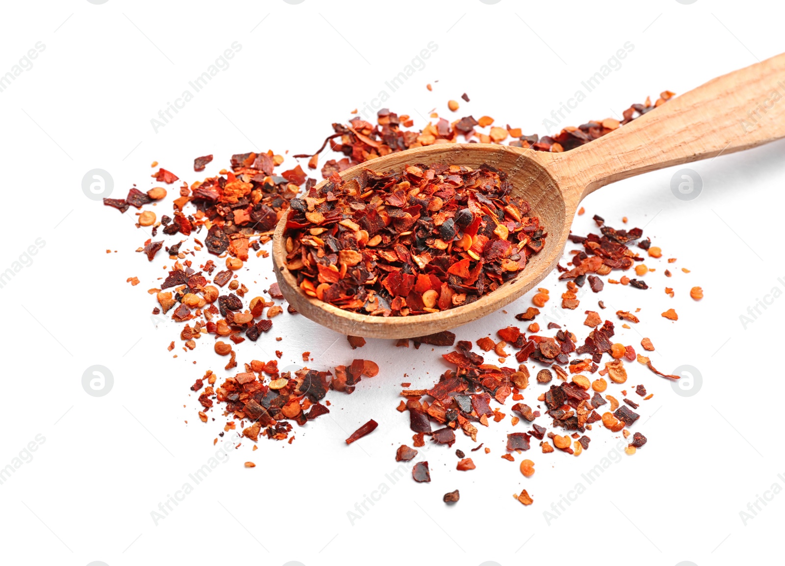 Photo of Wooden spoon and chili pepper flakes on white background