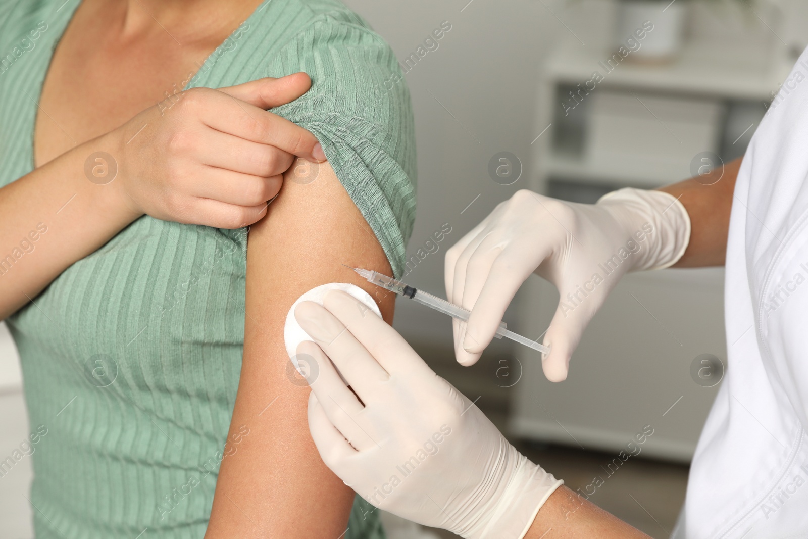 Photo of Doctor giving injection to patient in hospital, closeup. Vaccination day