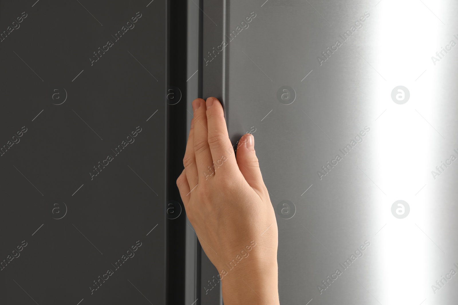 Photo of Woman opening refrigerator door, closeup. Space for text