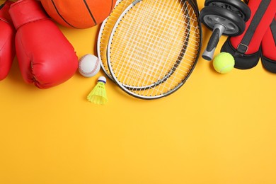 Photo of Set of different sports equipment on yellow background, flat lay. Space for text