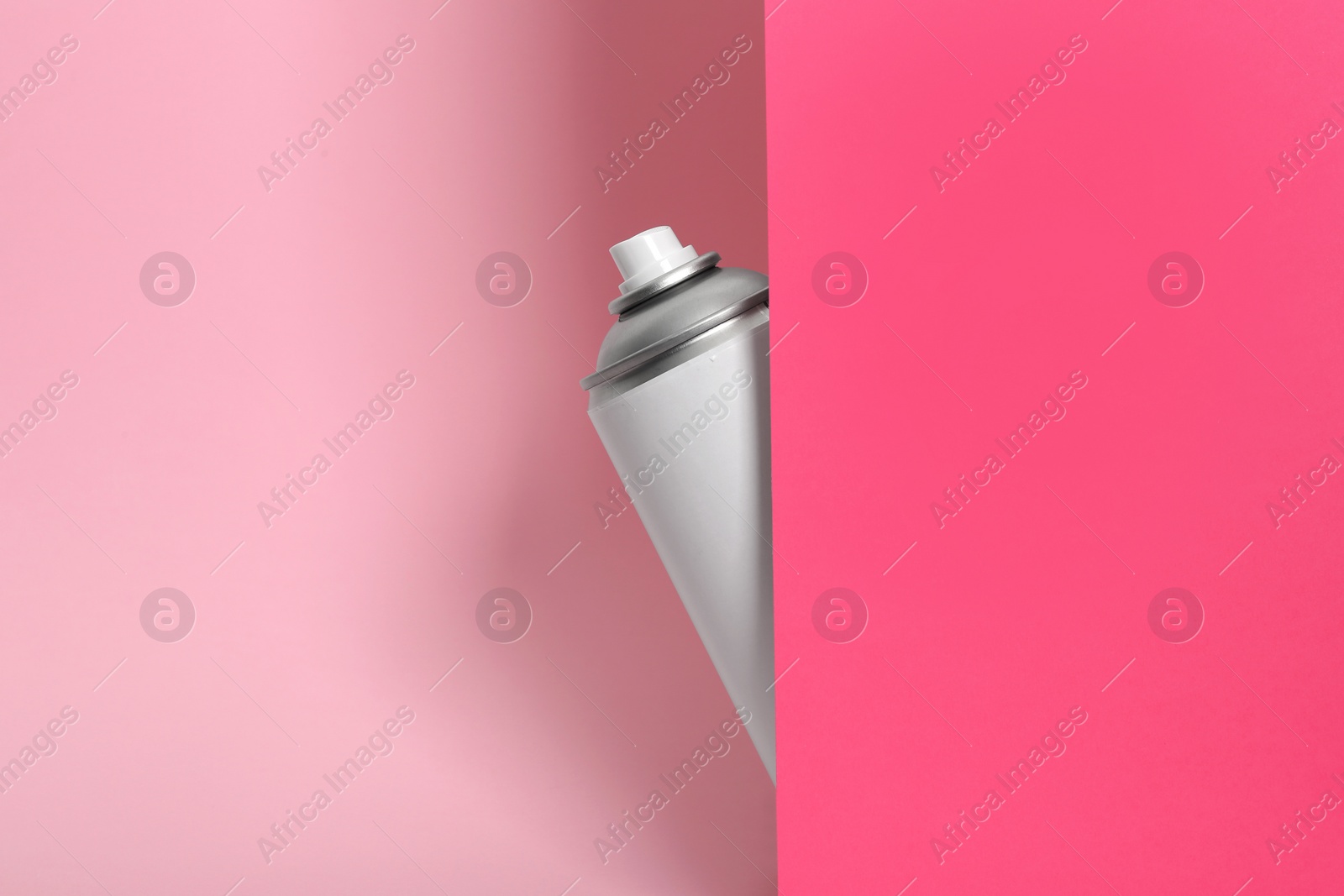 Photo of Can of spray paint on color background. Space for text