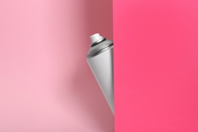 Photo of Can of spray paint on color background. Space for text