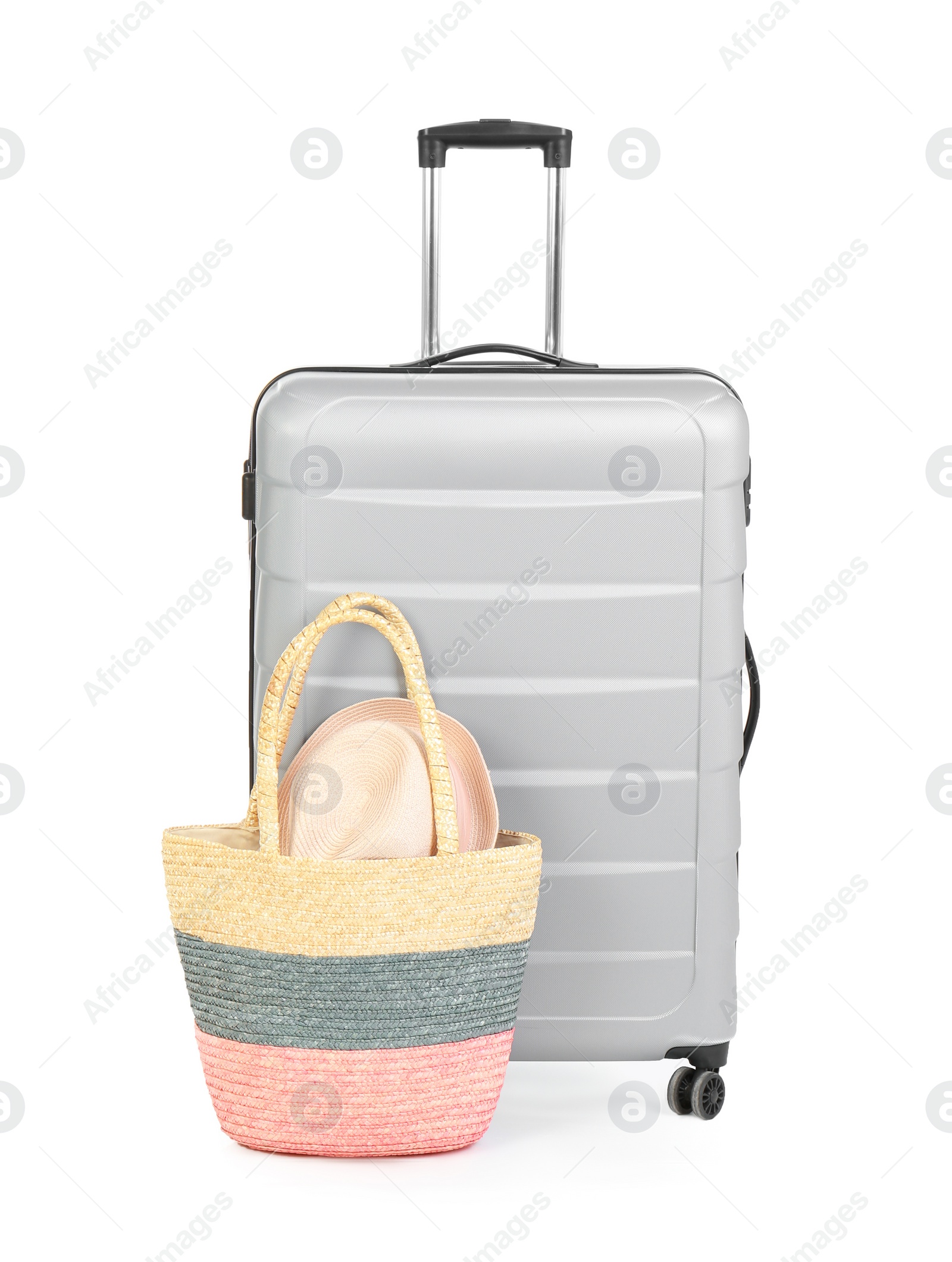 Photo of Suitcase and tote bag with hat on white background