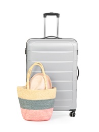 Photo of Suitcase and tote bag with hat on white background