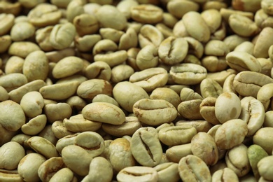 Photo of Many green coffee beans as background, closeup