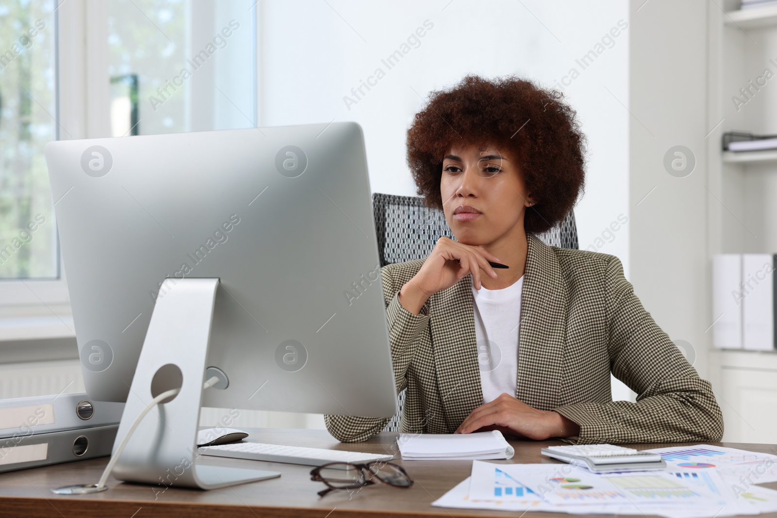 Photo of Professional accountant working on computer in office