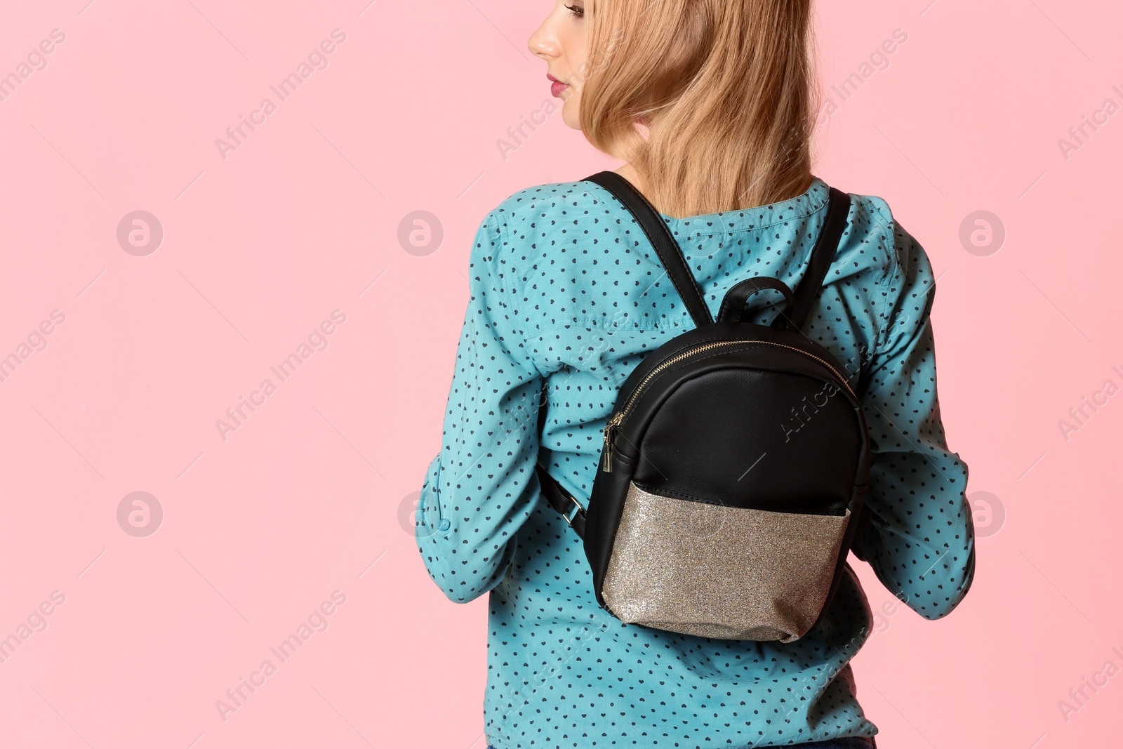 Photo of Fashionable woman with backpack on color background. Space for text