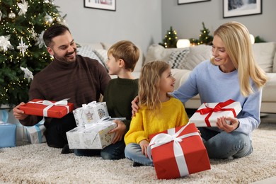 Happy family with Christmas gifts at home