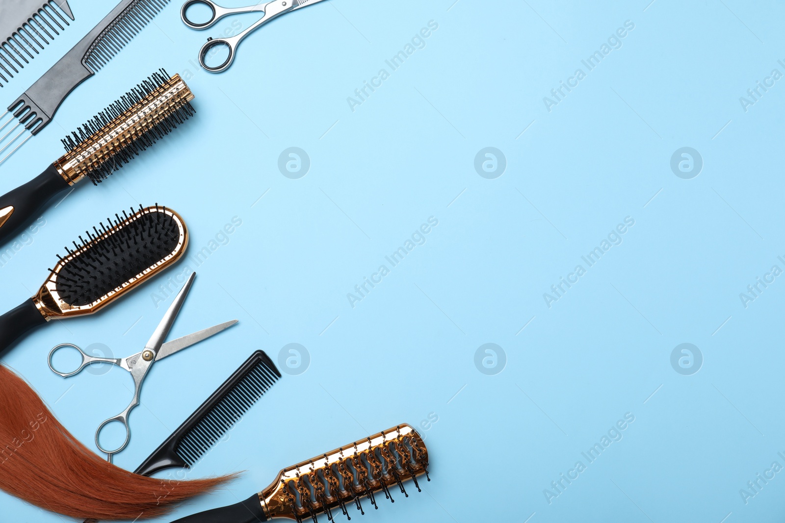 Photo of Professional hairdresser scissors and other equipment on turquoise background, flat lay with space for text. Haircut tools