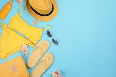 Photo of Flat lay composition with beach objects on light blue background, space for text