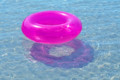 Photo of Bright inflatable ring floating on sea water