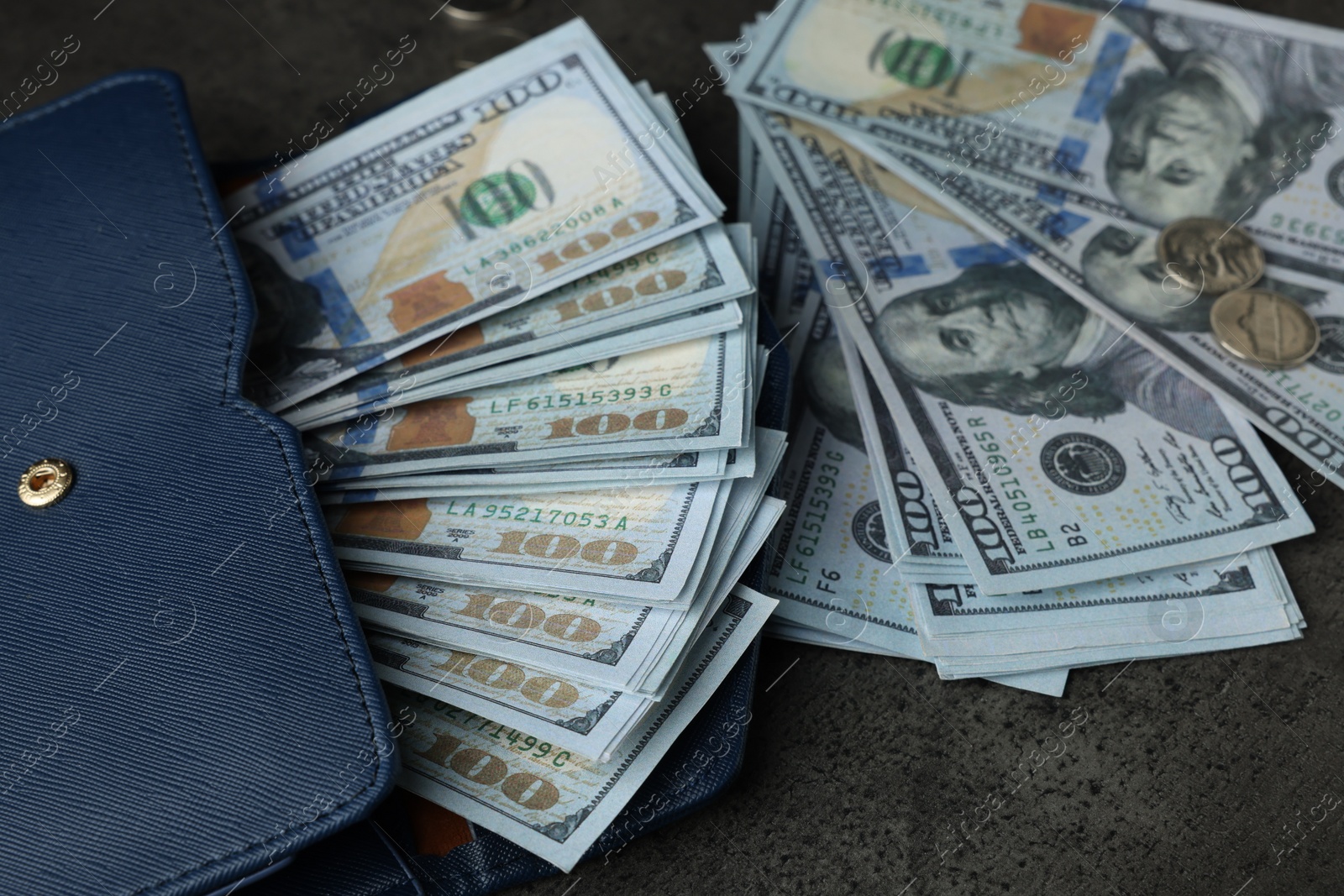 Photo of Dollar banknotes, coins and wallet on grey table, closeup. Money exchange