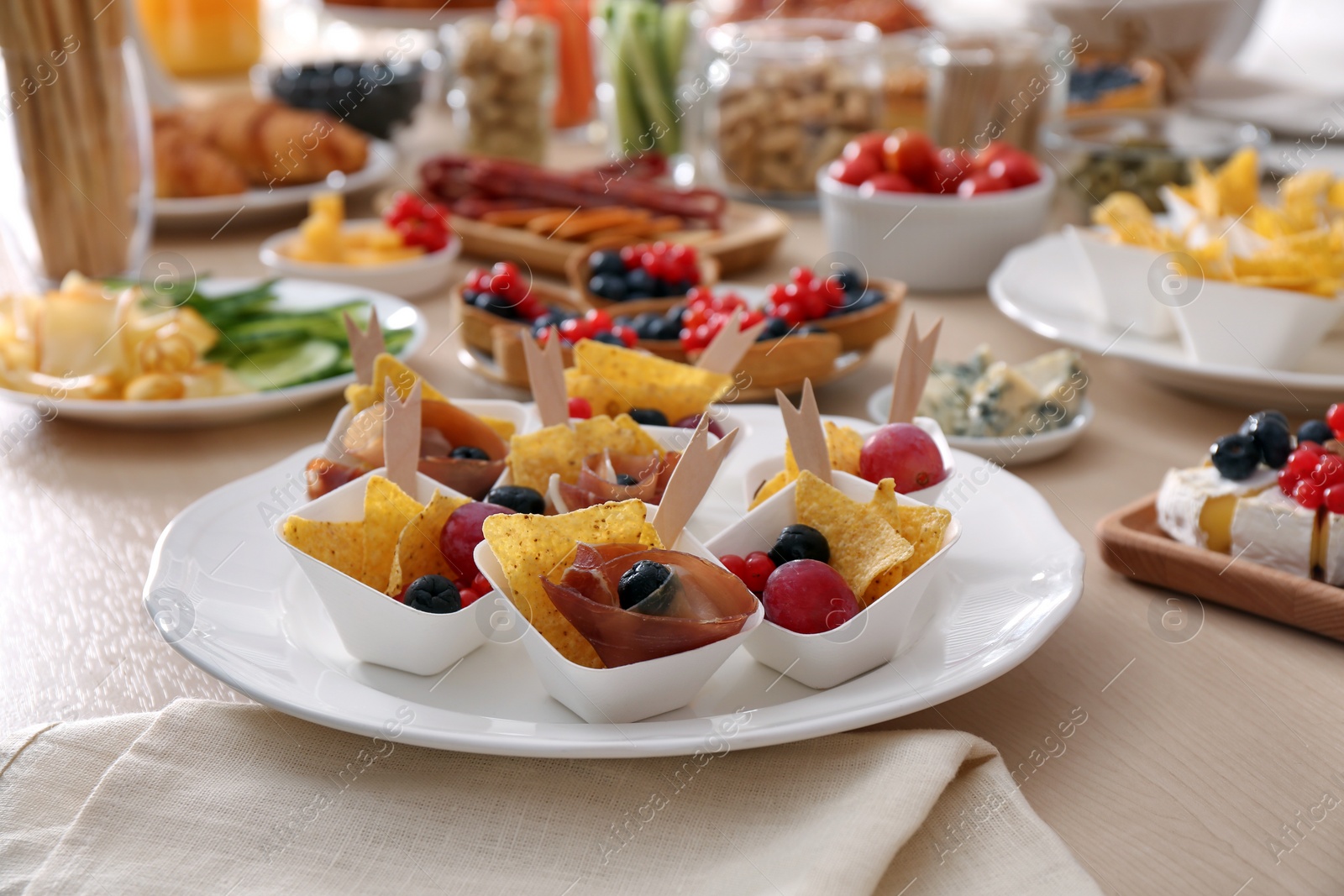 Photo of Variety of snacks on wooden table in buffet style