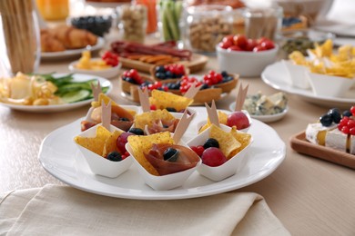 Variety of snacks on wooden table in buffet style