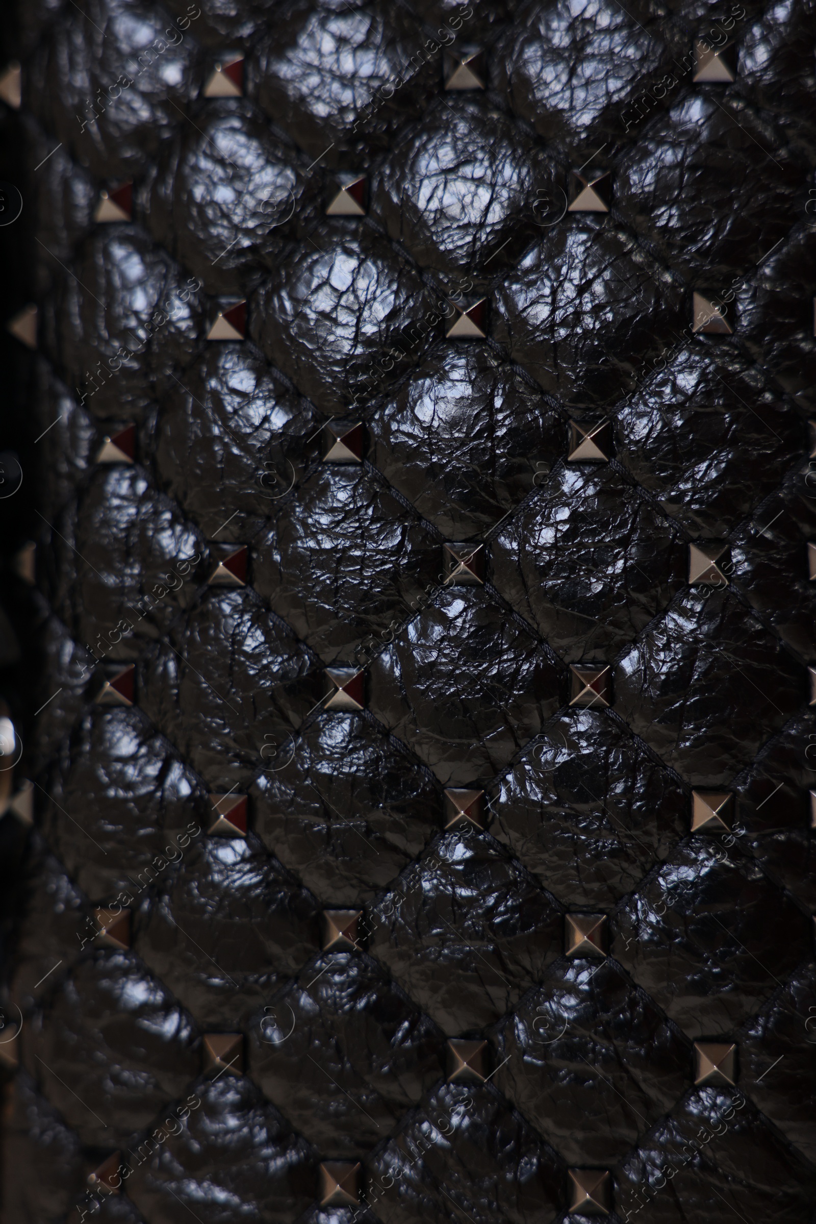 Photo of Texture of black leather bag as background, top view