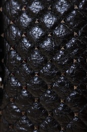 Photo of Texture of black leather bag as background, top view