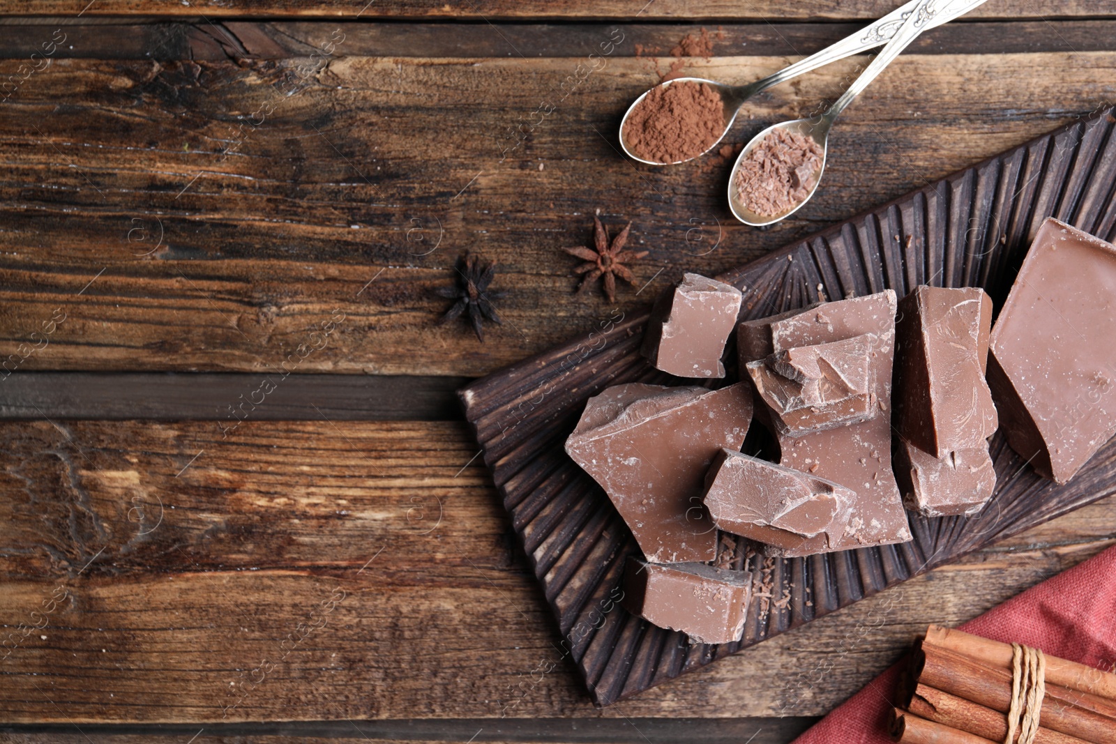 Photo of Flat lay composition with tasty milk chocolate on wooden table. Space for text