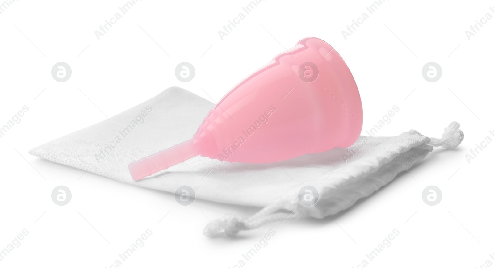 Photo of Pink menstrual cup with cotton bag on white background