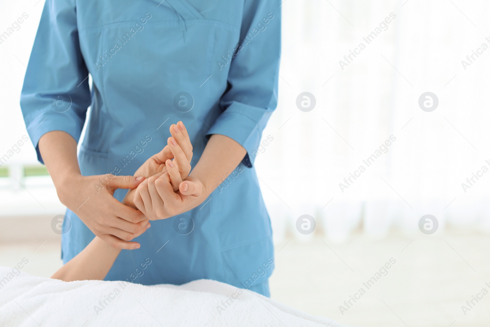 Photo of Woman receiving hand massage in wellness center